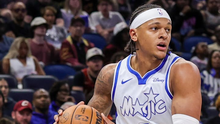 Mar 11, 2026; Orlando, Florida, USA; Orlando Magic forward Paolo Banchero (5) looks to pass in front of Cleveland Cavaliers forward Dean Wade (32) during the first quarter at Kia Center. Mandatory Credit: Mike Watters-Imagn Images