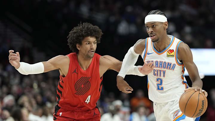 Mar 6, 2024; Portland, Oregon, USA; Oklahoma City Thunder point guard Shai Gilgeous-Alexander (2) dribbles the ball while defended by  Portland Trail Blazers shooting guard Matisse Thybulle (4) during the second half at Moda Center. Mandatory Credit: Soobum Im-Imagn Images