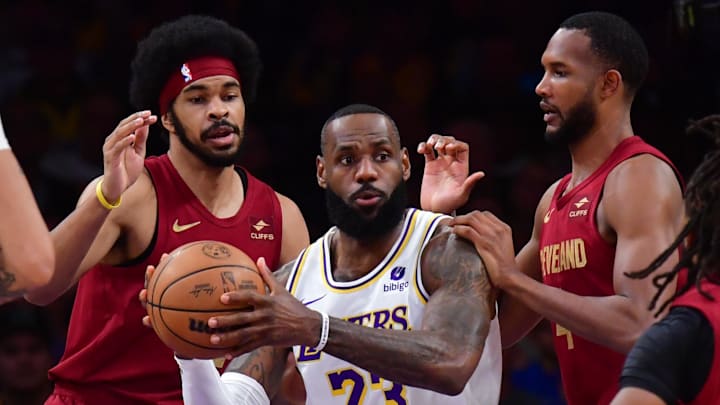 Apr 6, 2024; Los Angeles, California, USA; Los Angeles Lakers forward LeBron James (23) controls the ball against Cleveland Cavaliers center Jarrett Allen (31) forward Evan Mobley (4) and guard Darius Garland (10) during the first half at Crypto.com Arena. Mandatory Credit: Gary A. Vasquez-Imagn Images Apr 6, 2024; Los Angeles, California, USA; Los Angeles Lakers forward LeBron James (23) controls the ball against Cleveland Cavaliers center Jarrett Allen (31) forward Evan Mobley (4) and guard Darius Garland (10) during the first half at Crypto.com Arena. Mandatory Credit: Gary A. Vasquez-Imagn Images