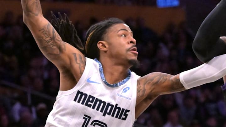 Jan 2, 2026; Los Angeles, California, USA; Memphis Grizzlies guard Ja Morant (12) defends Los Angeles Lakers forward Lebron James (23) as he drives to the basket during the first half at Crypto.com Arena. Mandatory Credit: Jayne Kamin-Oncea-Imagn Images