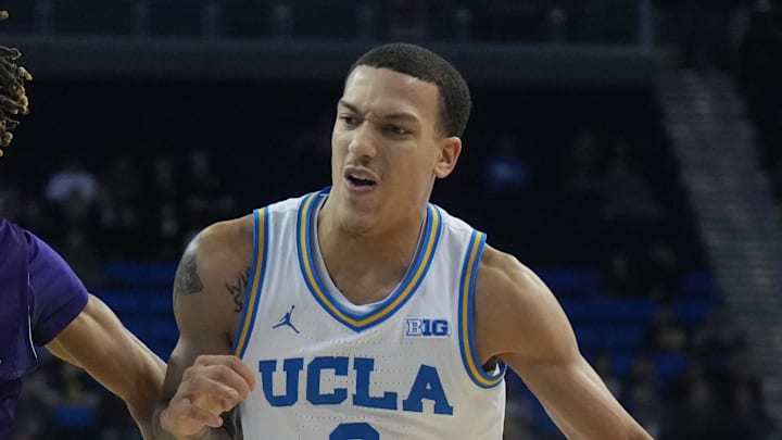 Dec 17, 2024; Los Angeles, California, USA; UCLA Bruins guard Kobe Johnson (0) dribbles the ball against Prairie View A&M Panthers guard Nick Anderson (23) in the second half at Pauley Pavilion presented by Wescom. Mandatory Credit: Kirby Lee-Imagn Images