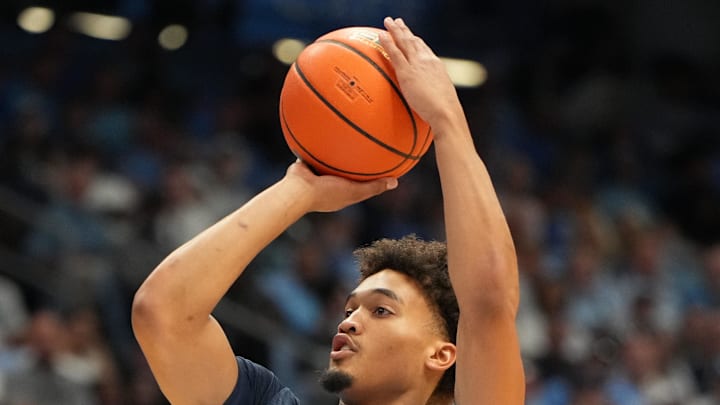 Oct 4, 2025; Charlotte, NC, USA; North Carolina Tar Heels guard Seth Trimble (7) shoots as guard Jaydon Young (4) defends in the second half at Dean E. Smith Center. Mandatory Credit: Bob Donnan-Imagn Images