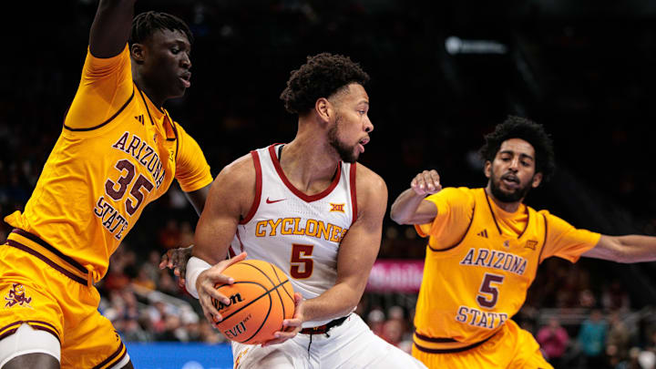 Mar 11, 2026; Kansas City, MO, USA; Iowa State Cyclones forward Joshua Jefferson (5) protects the ball from Arizona State Sun Devils center Massamba Diop (35) during the first half at T-Mobile Center. Mandatory Credit: William Purnell-Imagn Images