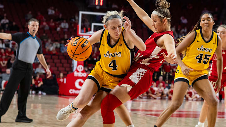 Nebraska guard Callin Hake draws a charge against Iowa. Nebraska guard Callin Hake draws a charge against Iowa.