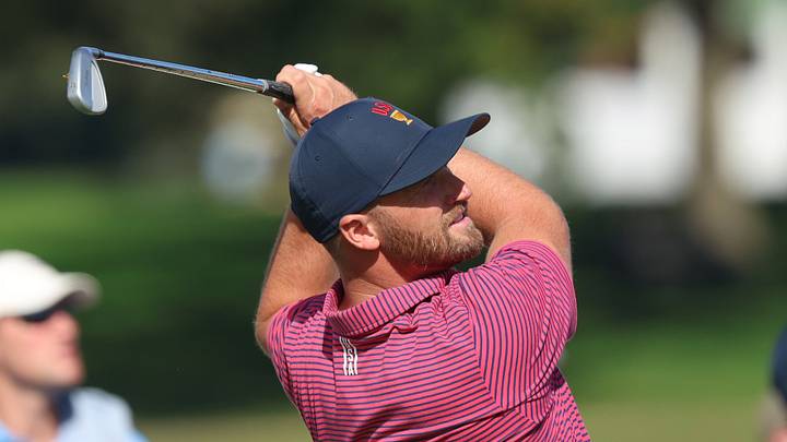 Wyndham Clark of the U.S. plays his shot from the 16th tee during the final round of the 2026 Presidents Cup; Jerod Ringwald