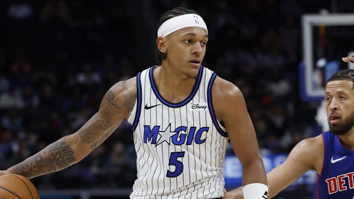 Oct 29, 2025; Detroit, Michigan, USA; Orlando Magic forward Paolo Banchero (5) dribbles while defended by Detroit Pistons guard Cade Cunningham (2) in the first half at Little Caesars Arena. Mandatory Credit: Rick Osentoski-Imagn Images