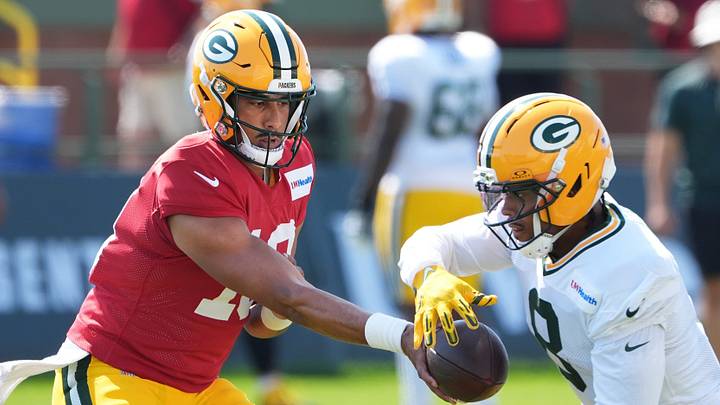 Green Bay Packers quarterback Jordan Love (10) hands off the ball to running back Josh Jacobs during training camp. Green Bay Packers quarterback Jordan Love (10) hands off the ball to running back Josh Jacobs during training camp.