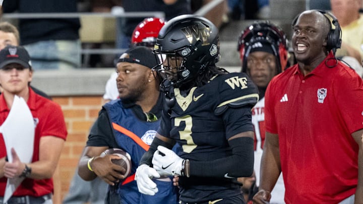 Sep 11, 2025; Winston-Salem, North Carolina, North Carolina State Wolfpack wide receiver Keenan Jackson (8) celebrates a first down against the Wake Forest Demon Deacons defensive back Karon Prunty (3) in second half at Allegacy Federal Credit Union Stadium. Mandatory Credit: Luke Jamroz-Imagn Images 