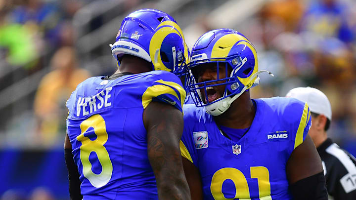 Oct 6, 2024; Inglewood, California, USA; Los Angeles Rams linebacker Jared Verse (8) and defensive tackle Kobie Turner (91) celebrate after sacking Green Bay Packers quarterback Jordan Love (10) during the first half at SoFi Stadium. Mandatory Credit: Gary A. Vasquez-Imagn Images