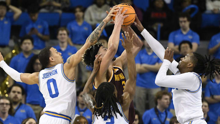 Feb 18, 2025; Los Angeles, California, USA; Minnesota Golden Gophers forward Dawson Garcia (3) is defended by UCLA Bruins guard Kobe Johnson (0), guard Dylan Andrews (2) and Sebastian Mack (12) during the second half at Pauley Pavilion presented by Wescom. Mandatory Credit: Robert Hanashiro-Imagn Images