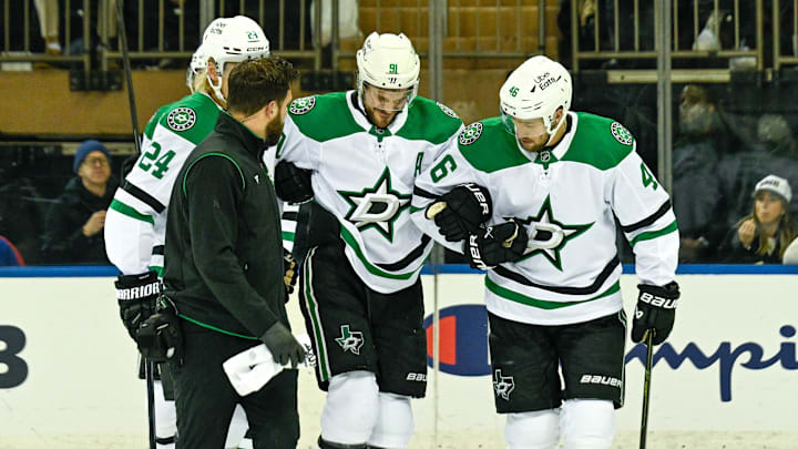 Dec 2, 2025; New York, New York, USA; Dallas Stars center Tyler Seguin (91) helped off the ice by Dallas Stars center Roope Hintz (24) and Dallas Stars defenseman Ilya Lyubushkin (46) in the game against the New York Rangers during the first period at Madison Square Garden. Mandatory Credit: Dennis Schneidler-Imagn Images Dec 2, 2025; New York, New York, USA; Dallas Stars center Tyler Seguin (91) helped off the ice by Dallas Stars center Roope Hintz (24) and Dallas Stars defenseman Ilya Lyubushkin (46) in the game against the New York Rangers during the first period at Madison Square Garden. Mandatory Credit: Dennis Schneidler-Imagn Images