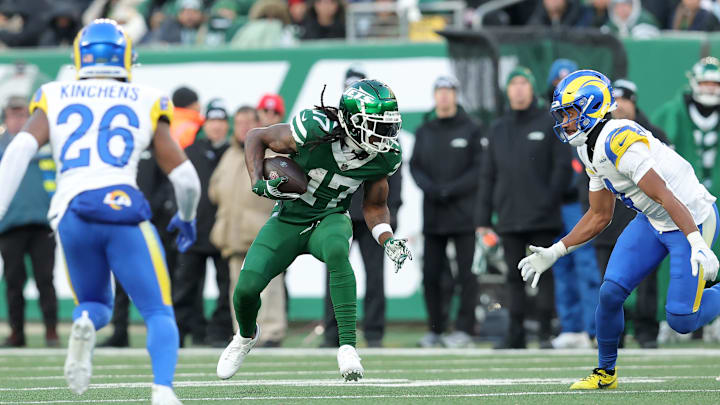 Dec 22, 2024; East Rutherford, New Jersey, USA; New York Jets wide receiver Davante Adams (17) runs with the ball against Los Angeles Rams safety Kamren Kinchens (26) and cornerback Ahkello Witherspoon (4) during the fourth quarter at MetLife Stadium. Mandatory Credit: Brad Penner-Imagn Images