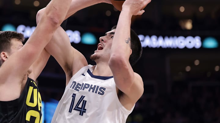 Oct 23, 2024; Salt Lake City, Utah, USA; Memphis Grizzlies center Zach Edey (14) tries to shoot the ball over Utah Jazz center Walker Kessler (24) during the second half at Delta Center. Mandatory Credit: Chris Nicoll-Imagn Images