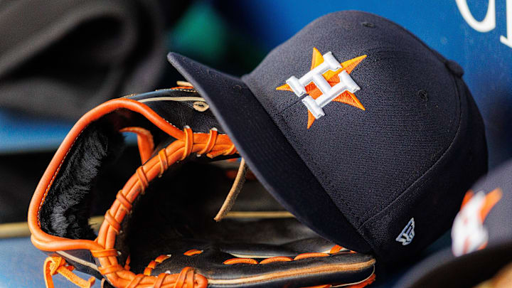 Apr 27, 2025; Kansas City, Missouri, USA; Houston Astros hat and glove in the dugout during the second inning against the Kansas City Royals at Kauffman Stadium. 