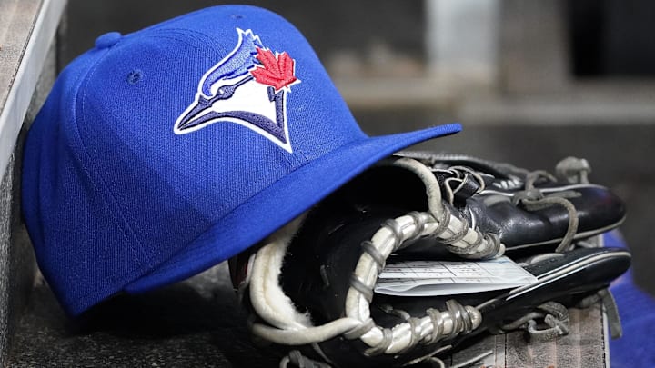 Apr 16, 2025; Toronto, Ontario, CAN; A Toronto Blue Jays hat and glove in the dugout during a game against the Atlanta Braves at Rogers Centre. Apr 16, 2025; Toronto, Ontario, CAN; A Toronto Blue Jays hat and glove in the dugout during a game against the Atlanta Braves at Rogers Centre.