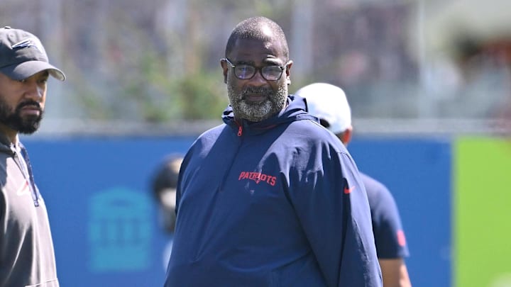 Jul 28, 2025; Foxborough, MA, USA; New England Patriots head coach Mike Vrabel (red sleeves and defensive coordinator Terrell Williams (blue pants) watch the team during training camp at Gillette Stadium. Mandatory Credit: Eric Canha-Imagn Images