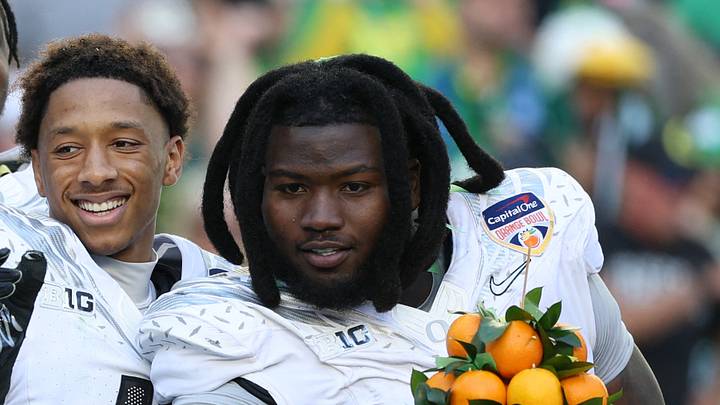 Jan 1, 2026; Miami Gardens, FL, USA; Oregon Ducks quarterback Dante Moore (5), wide receiver Malik Benson (4), defensive back Brandon Finney (4) and defensive lineman Bear Alexander (1) celebrate following the 2025 Orange Bowl and quarterfinal game of the College Football Playoff against the Texas Tech Red Raiders at Hard Rock Stadium. Mandatory Credit: Nathan Ray Seebeck-Imagn Images Jan 1, 2026; Miami Gardens, FL, USA; Oregon Ducks quarterback Dante Moore (5), wide receiver Malik Benson (4), defensive back Brandon Finney (4) and defensive lineman Bear Alexander (1) celebrate following the 2025 Orange Bowl and quarterfinal game of the College Football Playoff against the Texas Tech Red Raiders at Hard Rock Stadium. Mandatory Credit: Nathan Ray Seebeck-Imagn Images