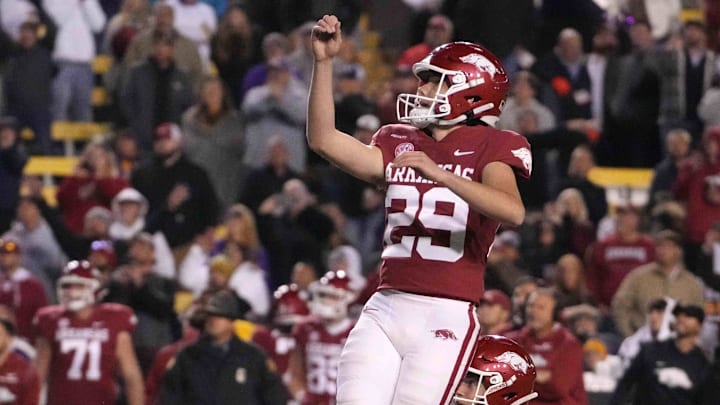 Arkansas Razorbacks place kicker Cam Little (29) follows through on a field goal out of the hold of punter Reid Bauer (30) against the LSU Tigers in overtime at Tiger Stadium. 