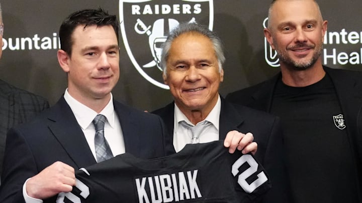 Feb 10, 2026; Las Vegas, NV, USA; Las Vegas Raiders coach Klint Kubiak (center) poses at introductory press conference at Intermountain Health Performance Center. From left: Marcus Allen, Mike Haynes, Howie Long, Kubiak, general manager John Spyktek, Charles Woodson and Rich Gannon. Mandatory Credit: Kirby Lee-Imagn Images