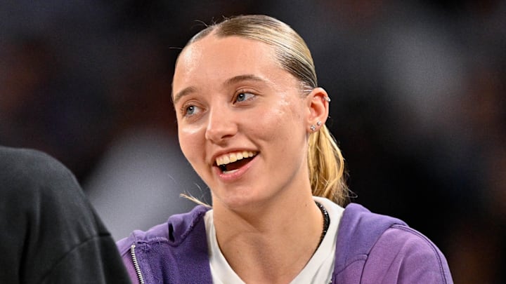 Oct 6, 2025; Fort Worth, Texas, USA; Dallas Mavericks guard Kyrie Irving (left) talks with Dallas Wings guard Paige Bueckers (right) during the second half of the game between the Mavericks and the Oklahoma City Thunder at Dickie's Arena. Mandatory Credit: Jerome Miron-Imagn Images