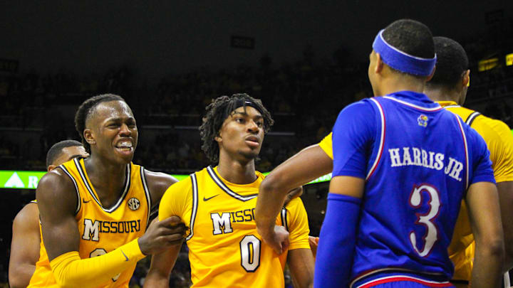 Dec 8, 2024; Columbia, Missouri, USA; Missouri Tigers guard Anthony Robinson (0) is held back by teammates Mark Mitchell (25) and Tamar Bates (2) during a game against the Kansas Jayhawks at Mizzou Arena.
