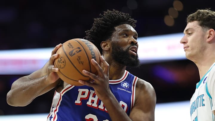 Oct 25, 2025; Philadelphia, Pennsylvania, USA; Philadelphia 76ers center Joel Embiid (21) drives against Charlotte Hornets center Ryan Kalkbrenner (11) during the first quarter at Xfinity Mobile Arena. Mandatory Credit: Bill Streicher-Imagn Images