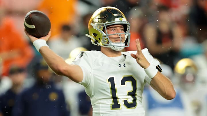 Aug 31, 2025; Miami Gardens, Florida, USA; Notre Dame Fighting Irish quarterback CJ Carr (13) drops back to pass against the Miami Hurricanes during the first quarter at Hard Rock Stadium. 