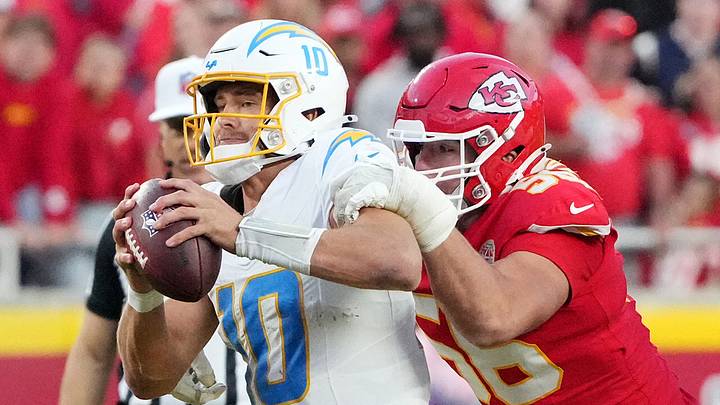 Los Angeles Chargers quarterback Justin Herbert (10) sacked by Kansas City Chiefs defensive end George Karlaftis (56).