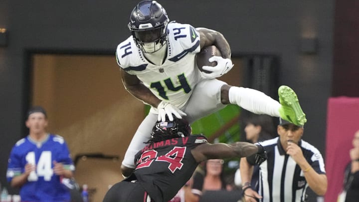 Seattle Seahawks wide receiver DK Metcalf (14) jumps over Arizona Cardinals cornerback Starling Thomas V (24) during the second quarter at State Farm Stadium in Glendale on Dec. 8, 2024.
