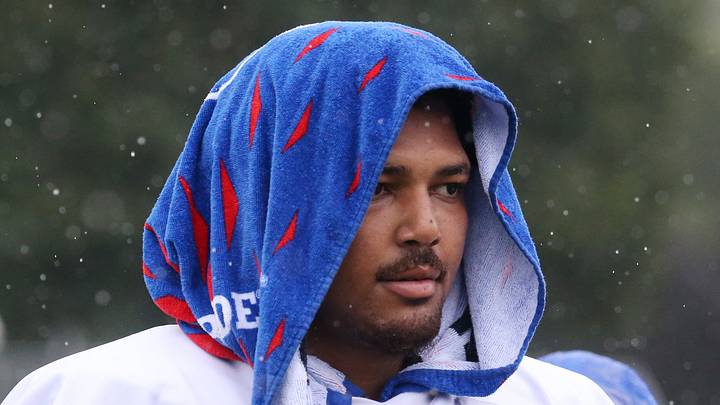 Bills linebacker TJ Parker covers up from the rain at the end of day four of Buffalo Bills training camp at St. John Fisher University Monday, August 3, 2026 in Pittsford.