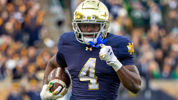 Nov 22, 2025; South Bend, Indiana, USA; Notre Dame Fighting Irish running back Jeremiyah Love (4) runs the ball against the Syracuse Orange during the first half at Notre Dame Stadium. 