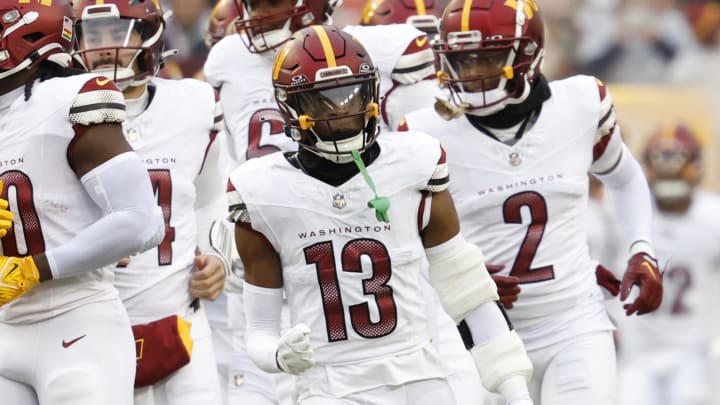 Jan 7, 2024; Landover, Maryland, USA; Washington Commanders cornerback Emmanuel Forbes (13) runs onto the field with teammates prior to their game against the Dallas Cowboys at FedExField. Mandatory Credit: Geoff Burke-USA TODAY Sports