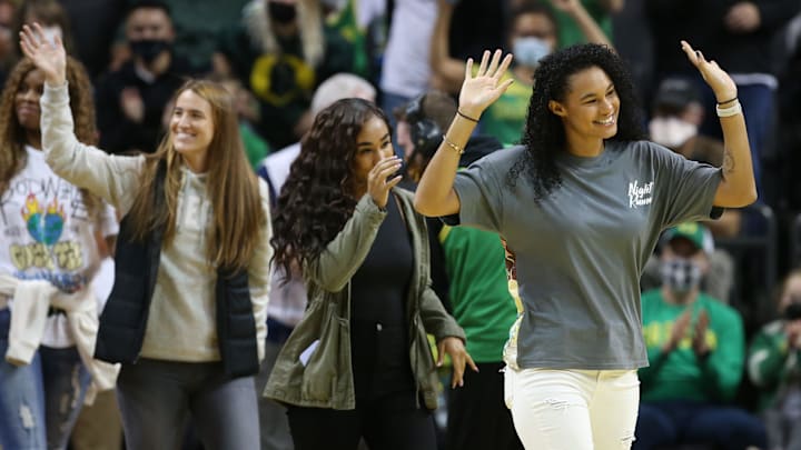 Former Oregon women's basketball players Satou Sabally, Minyon Moore, and Sabrina Ionescu wave to fans between quarters. Former Oregon women's basketball players Satou Sabally, Minyon Moore, and Sabrina Ionescu wave to fans between quarters.