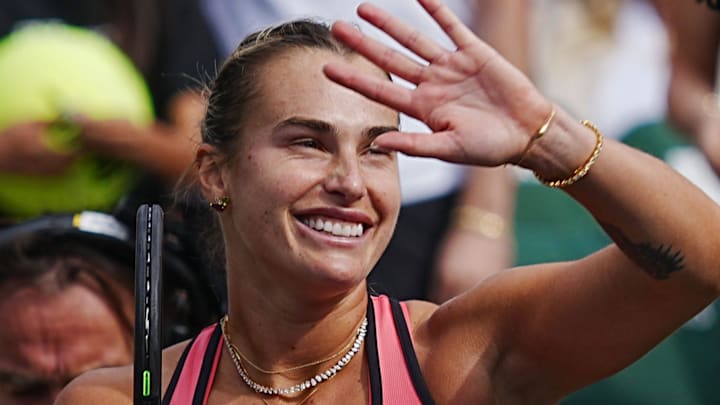 Aryna Sabalenka reacts to the crowd applause