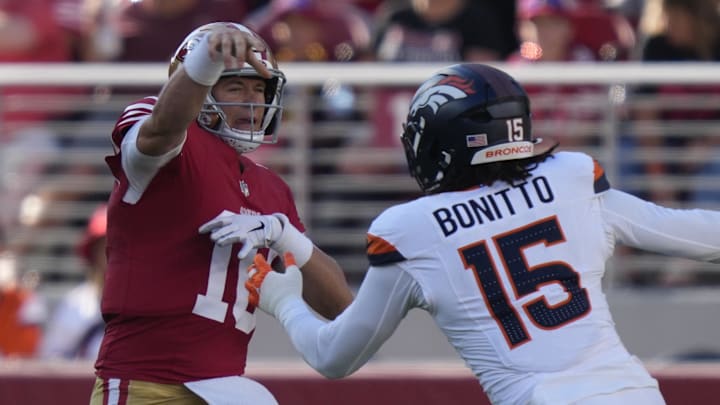 August 9, 2025; Santa Clara, California, USA; San Francisco 49ers quarterback Mac Jones (10) passes the football against Denver Broncos linebacker Nik Bonitto (15) during the first quarter at Levi's Stadium. 