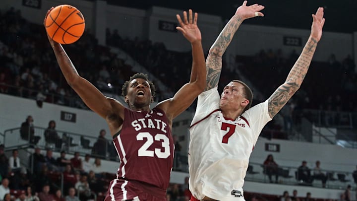Mississippi State Bulldogs guard King Grace (23) drives to the basket as Arkansas Razorbacks forward Trevon Brazile (7) defends during the second half at Humphrey Coliseum.