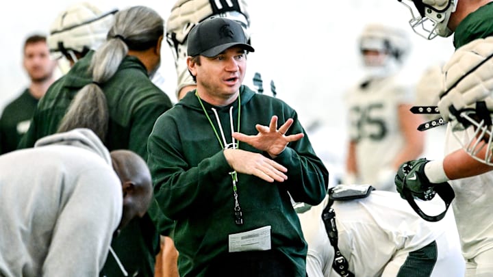 Michigan State's head coach Jonathan Smith, left, talks with Justin Bell during football practice on Tuesday, April 8, 2025, in East Lansing.