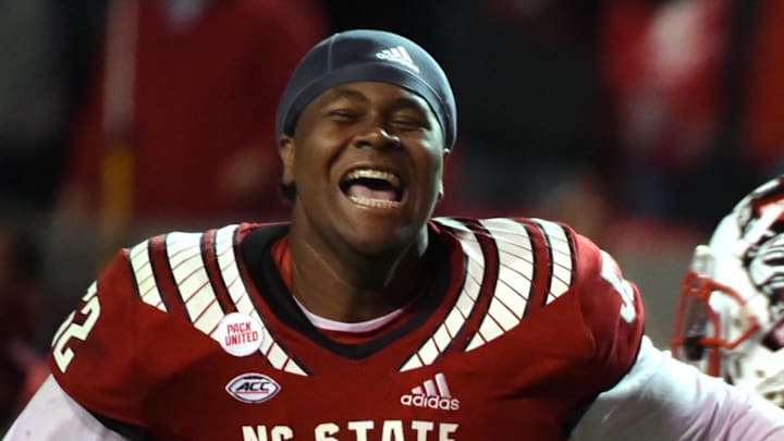 Nov 26, 2021; Raleigh, North Carolina, USA; North Carolina State Wolfpack linemen Grant Gibson (50) and Timothy McKay (52) celebrate after beating the North Carolina Tar Heels at Carter-Finley Stadium.  The Wolfpack won 34-30. Mandatory Credit: Rob Kinnan-Imagn Images