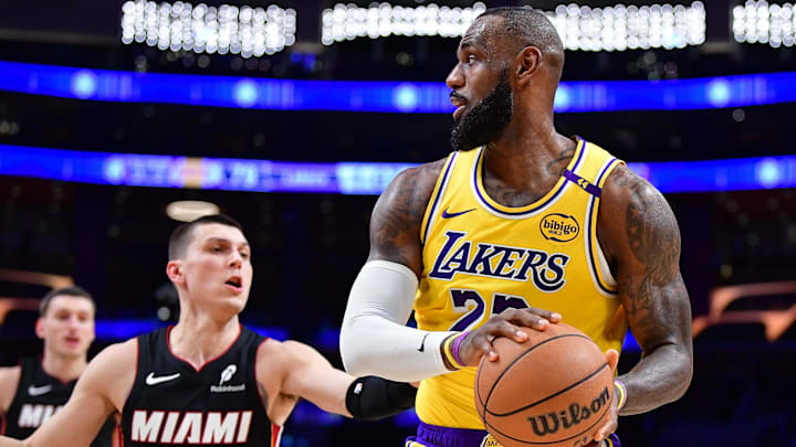January 15, 2025; Los Angeles, California, USA; Los Angeles Lakers forward LeBron James (23) moves the ball against Miami Heat guard Tyler Herro (14) during the second half at Crypto.com Arena. Mandatory Credit: Gary A. Vasquez-Imagn Images