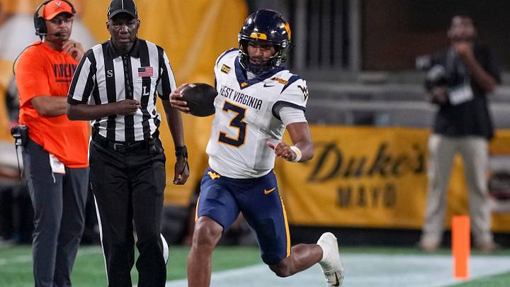 Sep 19, 2026; Charlotte, North Carolina, USA; West Virginia Mountaineers quarterback Michael Hawkins Jr. (3) runs along the sidelines for yards against the Virginia Cavaliers during the second half at Bank of America Stadium. Mandatory Credit: Jim Dedmon-Imagn Images Sep 19, 2026; Charlotte, North Carolina, USA; West Virginia Mountaineers quarterback Michael Hawkins Jr. (3) runs along the sidelines for yards against the Virginia Cavaliers during the second half at Bank of America Stadium. Mandatory Credit: Jim Dedmon-Imagn Images