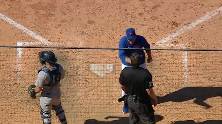 New York Mets manager Carlos Mendoza argues with umpire John Bacon after being ejected during a game against the New York Yankees.