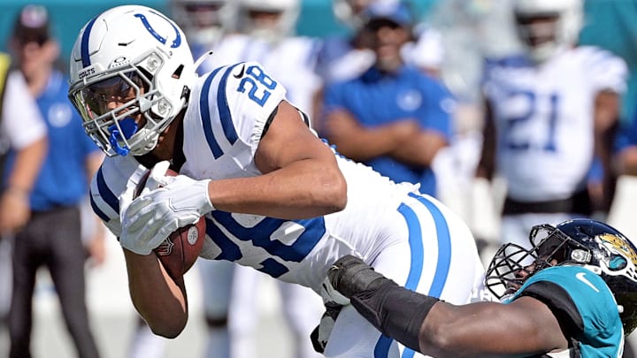 Oct 15, 2023; Jacksonville, Florida, USA; Indianapolis Colts running back Jonathan Taylor (28) is tackled by Jacksonville Jaguars linebacker Foyesade Oluokun (23) during the game at EverBank Stadium. Mandatory Credit: Melina Myers-Imagn Images