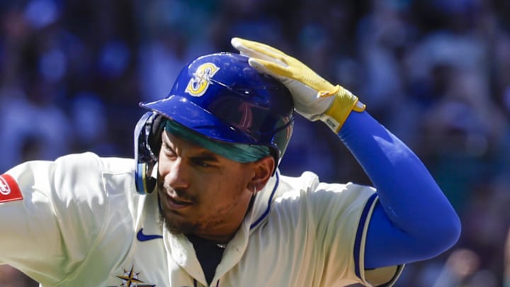 Seattle Mariners first baseman Josh Naylor (12) points to the Mariners dugout after hitting a solo-home run against the Tampa Bay Rays  during the seventh inning at T-Mobile Park on Aug. 10. 