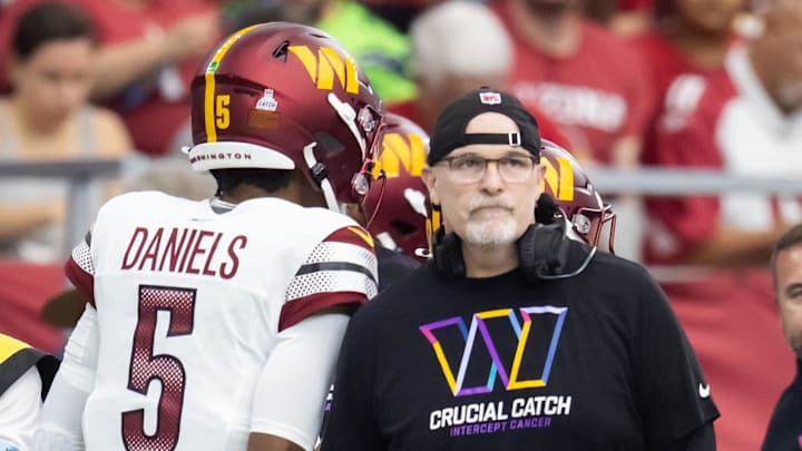 Sep 29, 2024; Glendale, Arizona, USA; Washington Commanders head coach Dan Quinn and quarterback Jayden Daniels (5) against the Arizona Cardinals at State Farm Stadium. Mandatory Credit: Mark J. Rebilas-Imagn Images