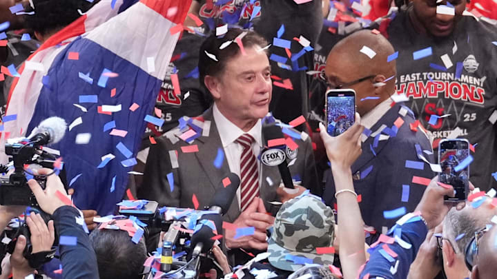 Pitino does a TV interview amid a celebration after winning the Big East tournament championship.