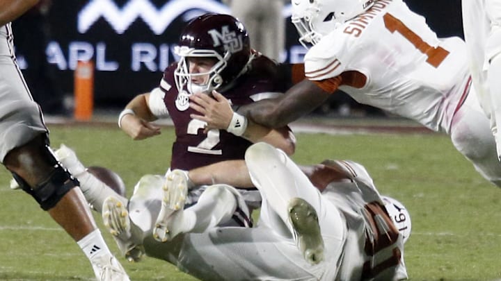 Texas Longhorns defensive linemen Ethan Burke (91) and Texas Longhorns defensive linemen Colin Simmons (1) force Mississippi State Bulldogs quarterback Blake Shapen (2) to fumble during overtime at Davis Wade Stadium at Scott Field. Texas Longhorns defensive linemen Ethan Burke (91) and Texas Longhorns defensive linemen Colin Simmons (1) force Mississippi State Bulldogs quarterback Blake Shapen (2) to fumble during overtime at Davis Wade Stadium at Scott Field.