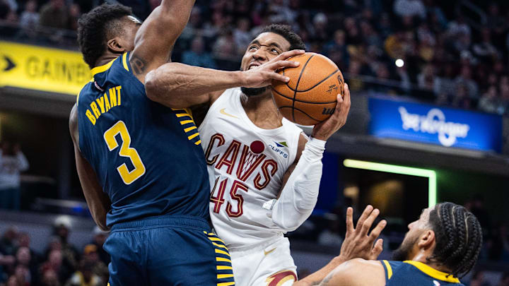 Jan 14, 2025; Indianapolis, Indiana, USA; Cleveland Cavaliers guard Donovan Mitchell (45) shoots the ball while Indiana Pacers center Thomas Bryant (3)  defends in the first half at Gainbridge Fieldhouse. Mandatory Credit: Trevor Ruszkowski-Imagn Images