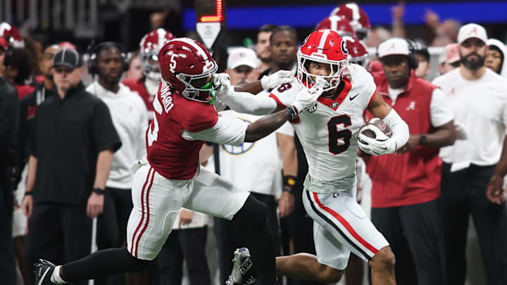 Dec 6, 2025; Atlanta, GA, USA; Georgia Bulldogs defensive back Daylen Everette (6) runs after an interception as Alabama Crimson Tide wide receiver Germie Bernard (5) attempts to tackle during the second quarter during the 2025 SEC Championship game at Mercedes-Benz Stadium. Mandatory Credit: Brett Davis-Imagn Images