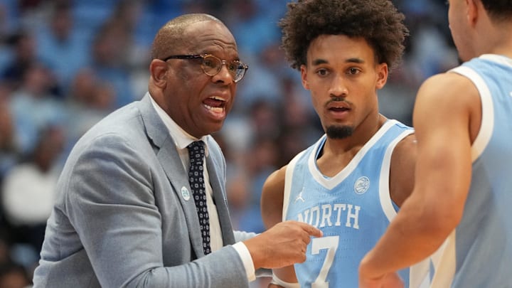 Dec 30, 2025; Chapel Hill, North Carolina, USA; North Carolina Tar Heels head coach Hubert Davis with guard Seth Trimble (7) and guard Derek Dixon (3) in the second half at Dean E. Smith Center. Mandatory Credit: Bob Donnan-Imagn Images