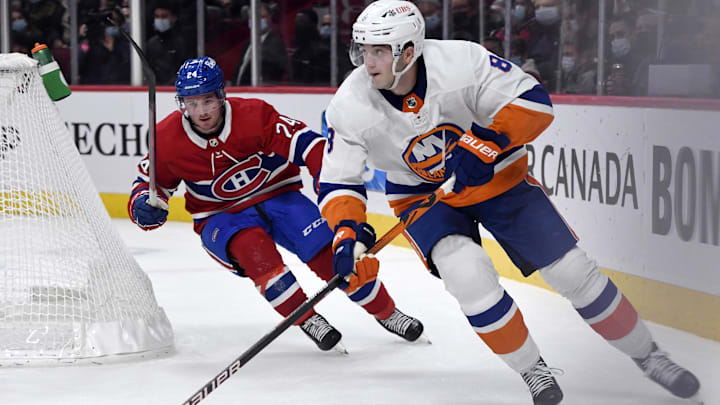 Nov 4, 2021; Montreal, Quebec, CAN; New York Islanders defenseman Noah Dobson (8) plays the puck and Montreal Canadiens forward Adam Brooks (24) gives chase during the first period at the Bell Centre. Mandatory Credit: Eric Bolte-Imagn Images